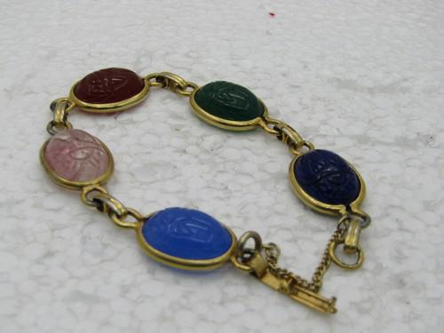 Vintage Scarab Gold Filled Bracelet, 6" with Safety Chain: Vintage Scarab Gold Filled Bracelet, 6" with Safety Chain, 12mm wide. 1960's, 16mm by 12mm, rose quartz, blue chalcadony, jadeite, carnelian lapis lazuli colored. 1960's. Good to very good condition. 