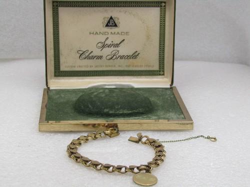 Vintage 12kt G.F. JB Spiral Charm Bracelet in Original Box, 7.25": Vintage 12kt G.F. JB Spiral Charm Bracelet in Original Box, 7.25", textured hearts sit over triple spiral links. there is a single charm that is engraved BSD. The links are 8mm wide. It is marked 12kt