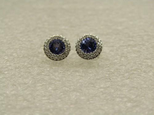 14kt 5mm Tanzanite Diamond Halo Earrings, 8mm Round, With Tags.: 14kt 5mm Tanzanite Diamond Halo Earrings, 8mm Round, With Tags. The earrings are 8mm wide with a center 5mm tanzanite stone and a diamond halo. They are signed 14kt and SDIL. Weight is appx. 2.13 gram