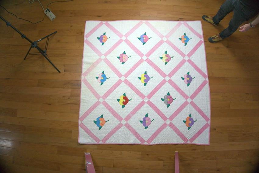 Flowered Appliqué Quilt: Title: Flowered Appliqué Quilt Date/Period: c.1945 Dimension: 80x78 Materials: Cotton thread and fabric. Provenance: Colored flowers on white set in individual squares with sashing. Shipping: Dom