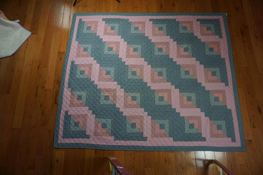 Log Cabin Quilt: Title: Log Cabin Date/Period: c. 1980 Dimension: 84x98 Materials: Cotton fabric and threads. Provenance: Pinks and grays. Machined pieced and machine quilted. Shipping: Domestic: Flat-rate of Shipping
