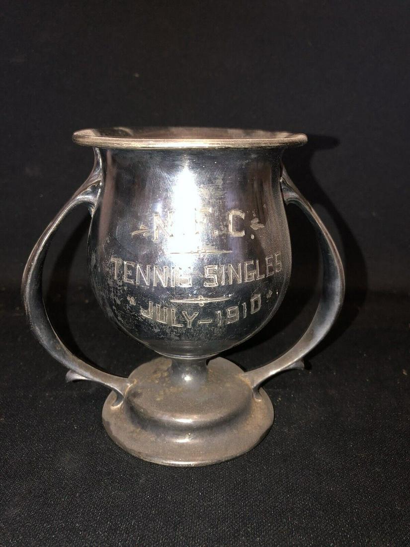 1910 5 1/4” NFC Tennis Loving Cup Trophy: It measures 5 1/4” x 5 7/8” and is dated 1910. It has wear as shown in the photos Shipping: Domestic: Flat-rate of $15.00 to anywhere within the contiguous U.S. International: Foreign ship