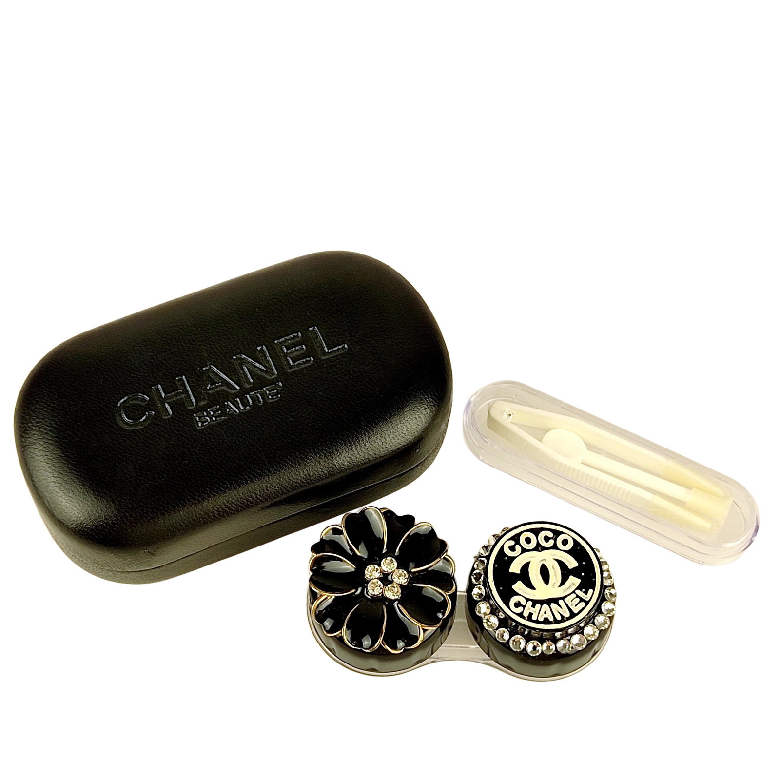 CHANEL Contact lens box: Title: CHANEL Contact lens box Material: Plastic Size/Dimensions: N/A Description: (4826). Contact lens box FEATURES: Exclusive women's accessory. In black plastic with white rhinestones and white pai