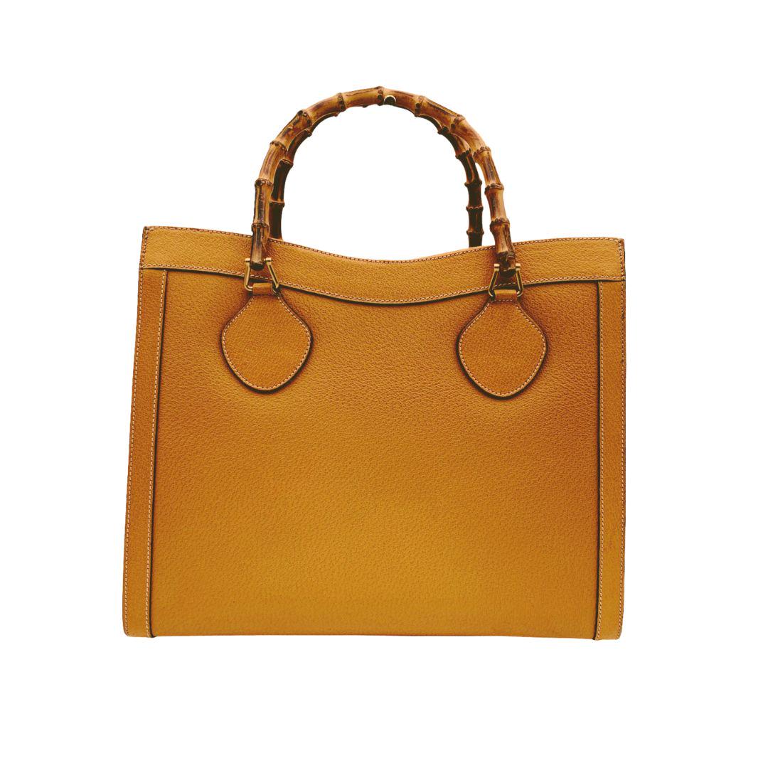 Gucci Vintage Yellow Leather Princess Diana Bamboo Tote Bag: Beautiful Gucci Bamboo tote bag in yellow mustard leather. Double distinctive Bamboo handle. Princess Diana was snapped carrying a this model on several occasions. Magnetic button closure on top. 5 bo