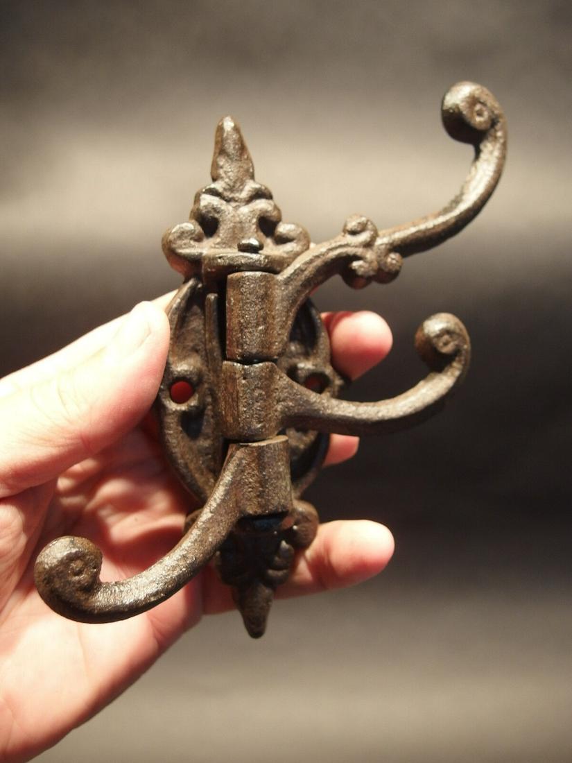 Cast Iron Wall Hook Swivel Folding Coat Hanger: 1) Hook 5 1/2" Tall.. 2" Wide 4" Extension Great sturdy iron wall hook cast from an antique. 3 folding arms Great textured black/brown color powder coat... a very sturdy finish. Reserve: $15.00 Shippi