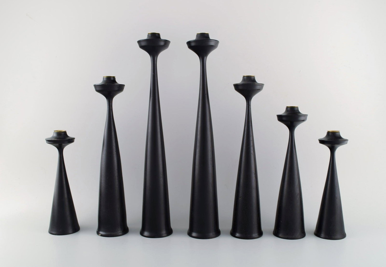 A collection of seven Scandinavian designer candlesticks in wood and brass. Modernist and clean (1 of 8)