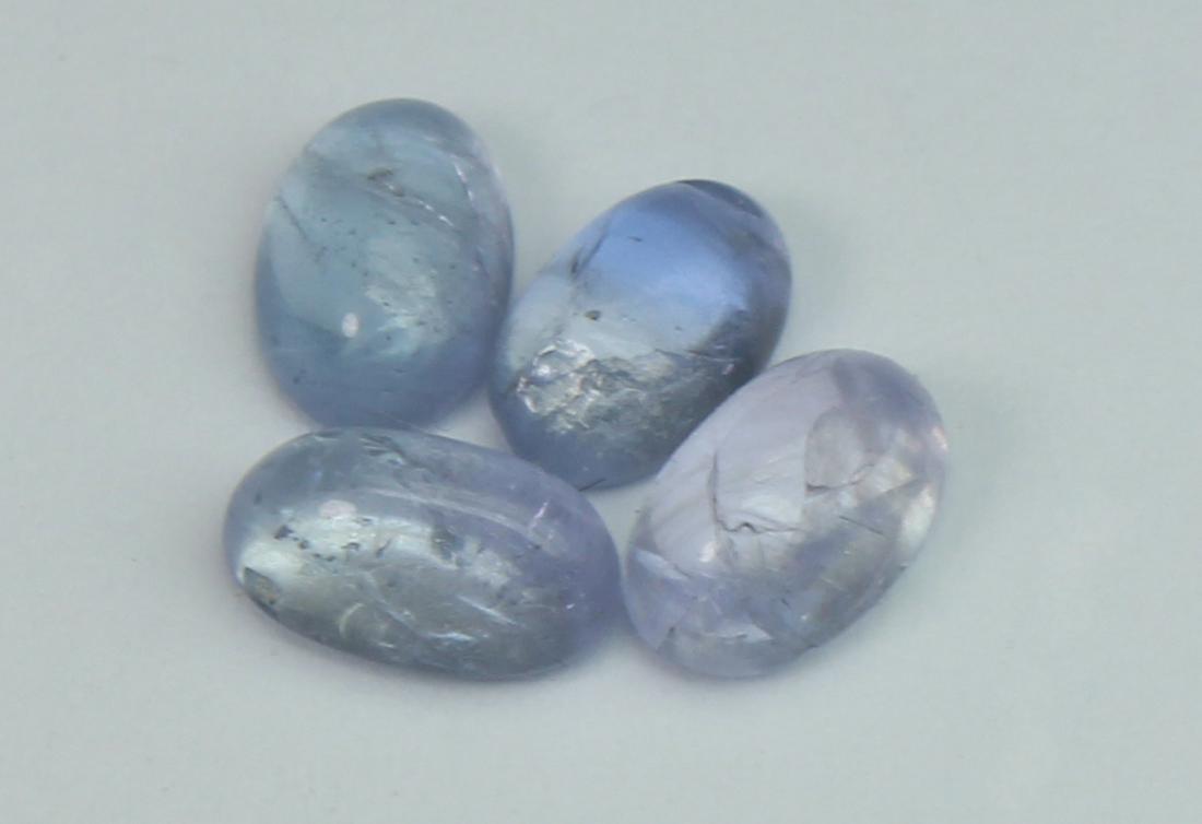 1.96 Cts Natural Tanzanite Lot: No Reserve! Gemstone : Natural Tanzanite Origin: Tanzania Weight : 1.96 carats Dimensions : 5.89x3.68x2.73 mm, 5.49x3.52x2.18 mm, (Calibrated) Shape/Cut: Oval Cabochon Number of Stone : 4 Color : Viol