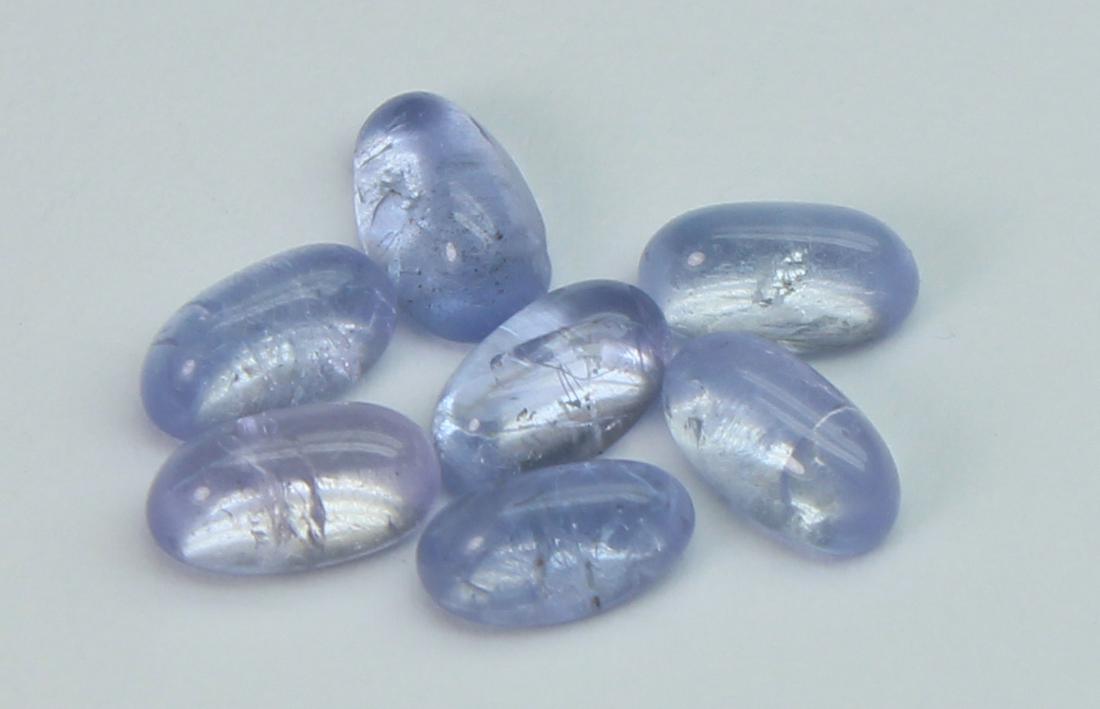 1.98 cts Natural Tanzanite: No Reserve! Gemstone : Natural Tanzanite Origin: Tanzania Weight : 1.98 carats Dimensions : 5.04x3.13x2.09 mm 4.76x2.70x2.10 mm Shape/Cut: Oval Cabochon Color : Violet Number of Stone : 7 Transparency