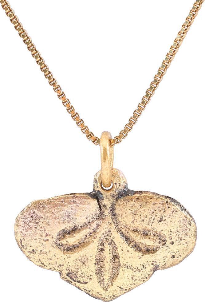 FINE VIKING HEART PENDANT, 9TH-10TH CENTURY AD: Gilt bronze. Just under 5/8" total height (0.62")" with raised edge defining the cusped top heart. The field with a well-delineated foliate trefoil dividing it into three segments. The trefoil is a fa