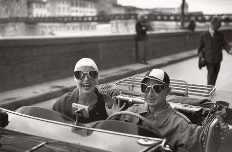 RUTH ORKIN - Couple in MG, Florence, 1951: Artist: Ruth Orkin Title: Couple in MG, Florence, 1951 Medium: Photo Litho, 1991, France Dimensions: 11x7.25" Description: Unmounted Artist Bio: Ruth Orkin (1921 - 1985) was an American photographer,