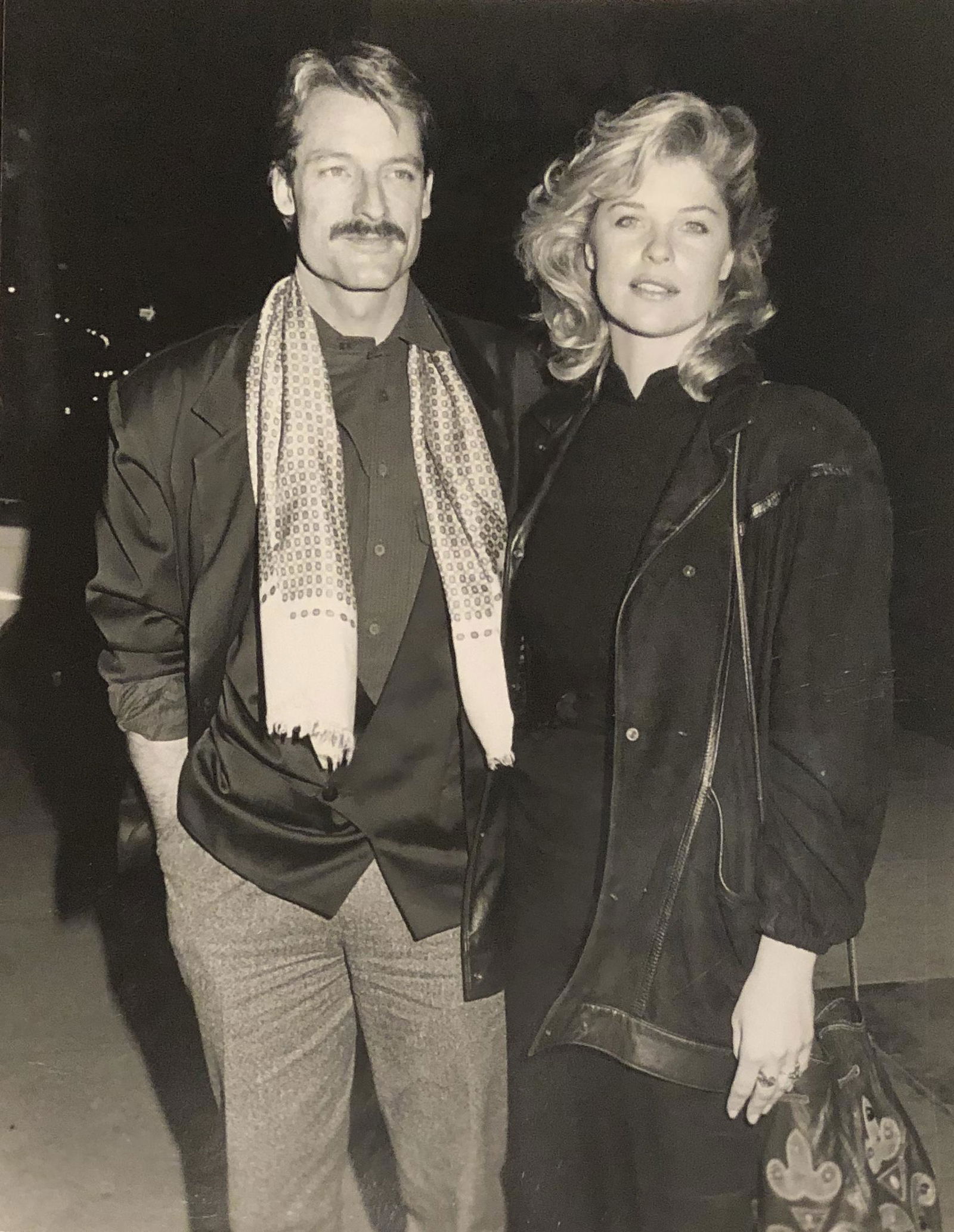 Perry King of Riptide w/ date Kate Vernon - 1987: Taken Jan 20, 1987 by noted photographer Janet Gough w/ photographer stamp and description verso. 9x7 on Kodak paper. Please note that this lot has a confidential reserve. When you leave a bid in adva