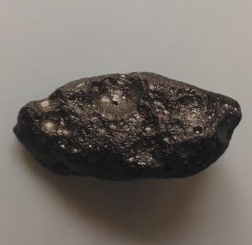 PHILIPPINITE TEKTITE - FROM METEORITE IMPACT: Title: PHILIPPINITE TEKTITE - FROM METEORITE IMPACT Origin: Paracale, Camarines Norte, Luzon, Philippines Size: 2x1x0.7 cm 2 gram Description: small perfect philippinite tektite with pitted surface st