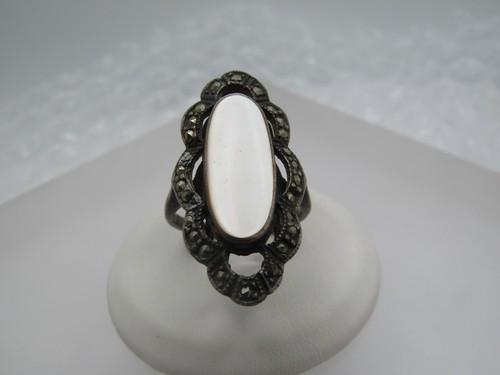 Vintage MOP Marcasite Ring, Sz. 7.5, 1980's: Vintage MOP Marcasite Ring, Sz. 7.5, 1980's. It is 1.25" down the finger and just shy of 3/4" across the finger. It is marked .925 and tested with a weight of appx. 5.96 gr. The mother-of-pearl is a b