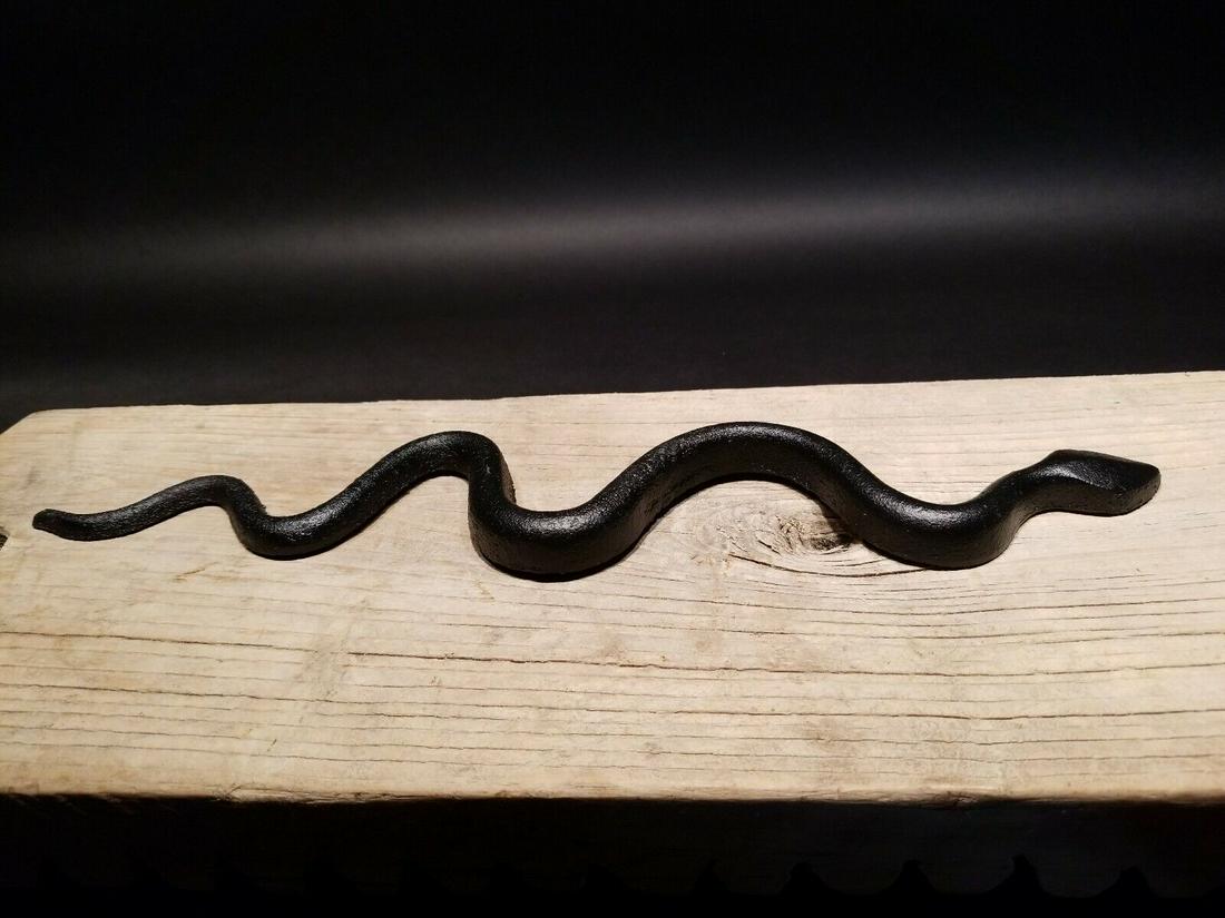 Cast Iron Snake Good Luck Charm: 14 3/8" Long Such a neat reproduction black cast iron snake. Small iron serpents such as this were kept at hearth mantles and around homes with the primitive belief that they contained the ability to 