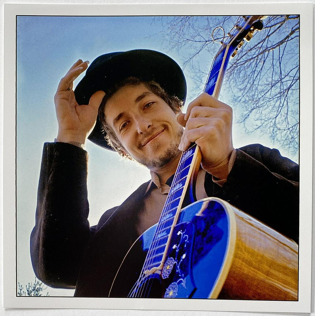 Bob Dylan: Woodstock NY 1969: Title: Woodstock NY 1969 Artist: Bob Dylan Medium: Color photograph Dimensions: 6" x 6" sheet Additional Information: signed in pen verso Reserve: $220.00 Shipping: Domestic: Flat-rate of $15.00 to an