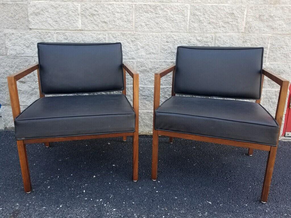 Mid Century Modern Ward Bennett Style Wood Black Leather Armchairs - Pair: Vintage from the 1970s Materials: leather, wood Overall width: 21 inches Overall height: 30 inches Overall depth: 26 inches Seat height: 19 inches Description Vintage Mid Century Modern Pair of Rare W