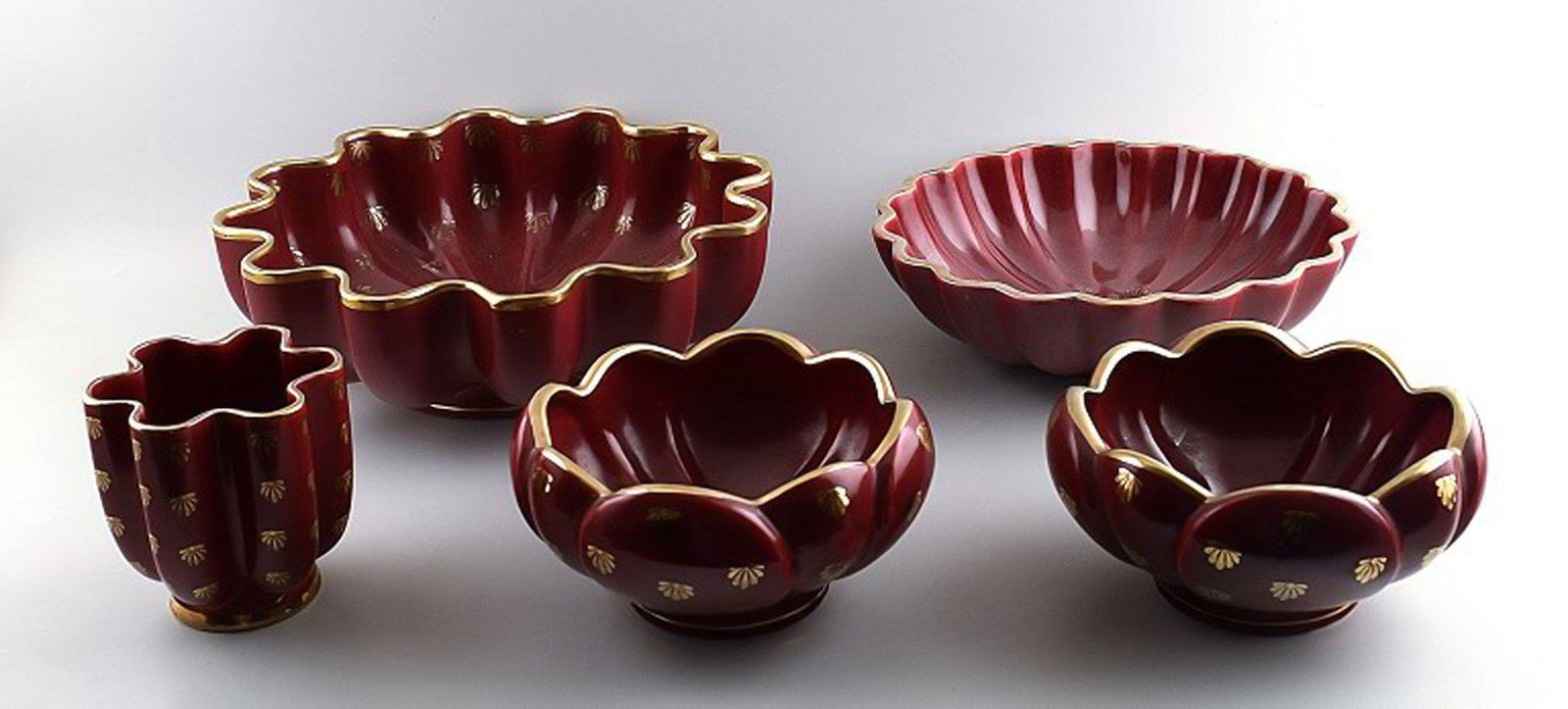 Collection of 'Red Rubin' pottery with red glaze with gold, Upsala-Ekeby, Gefle. Design Arthur: Title: Collection of 'Red Rubin' pottery with red glaze with gold, Upsala-Ekeby, Gefle. Design Arthur Percy. Brand: Upsala Ekeby Description: Collection of 'Red Rubin' pottery with red glaze with gold