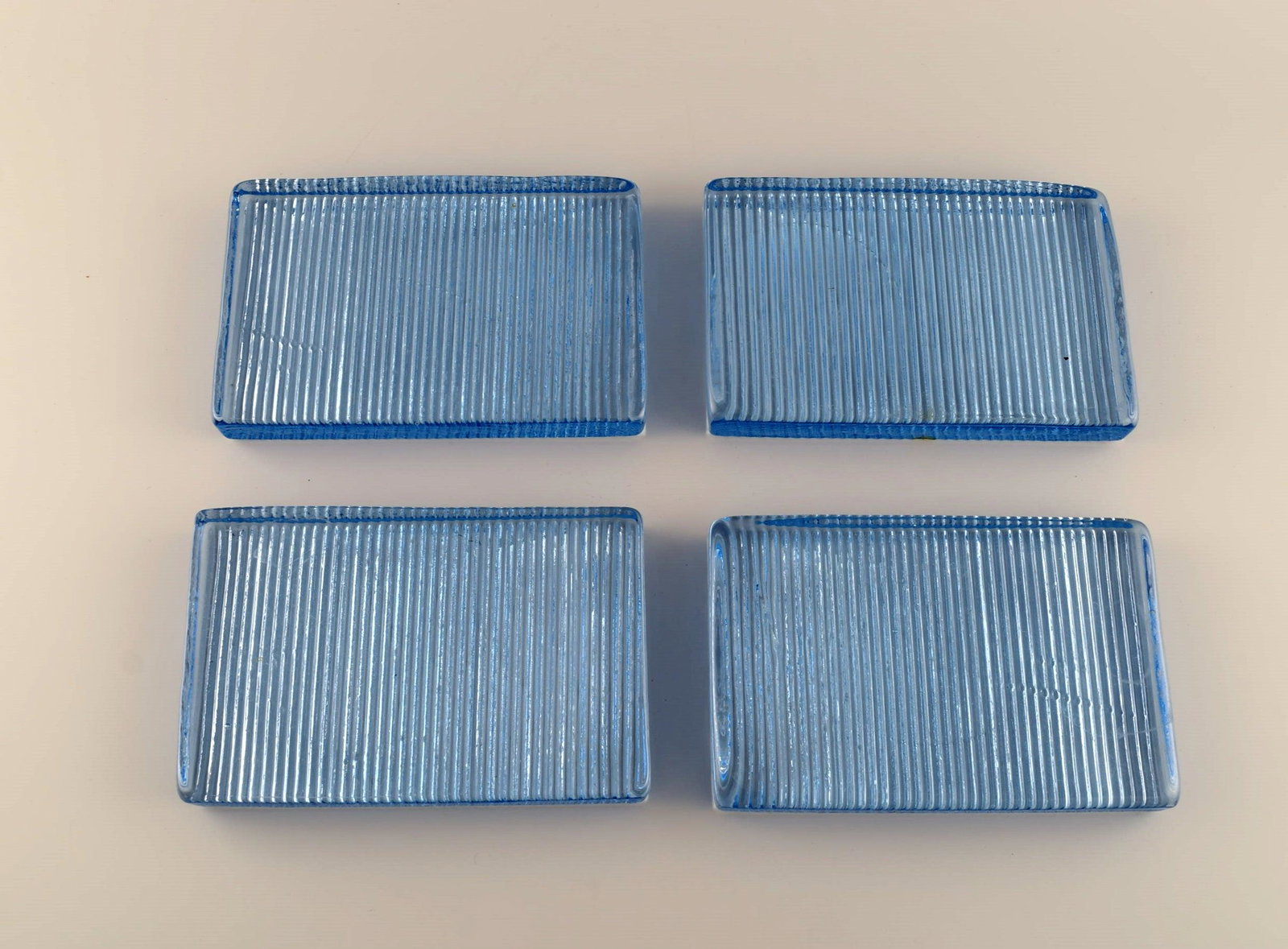 Per Lütken for Holmegaard. Four "Buffet" butter boards in light blue mouth blown art glass. 1980s.: Per Lütken for Holmegaard. Four "Buffet" butter boards in light blue mouth blown art glass. 1980s. Measures: 18 x 12 x 2.5 cm. In excellent condition. Reserve: $175.00 Shipping: Domestic: Shippin