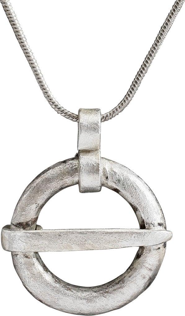 VIKING PROTECTIVE BROOCH, C.900-1050 AD: Silvered bronze of broad form, just under 7/8" in diameter. Broad rounded face front and back meeting as a ridged edge. When fastened to the jerkin, these small metal brooches provided a measure of pr