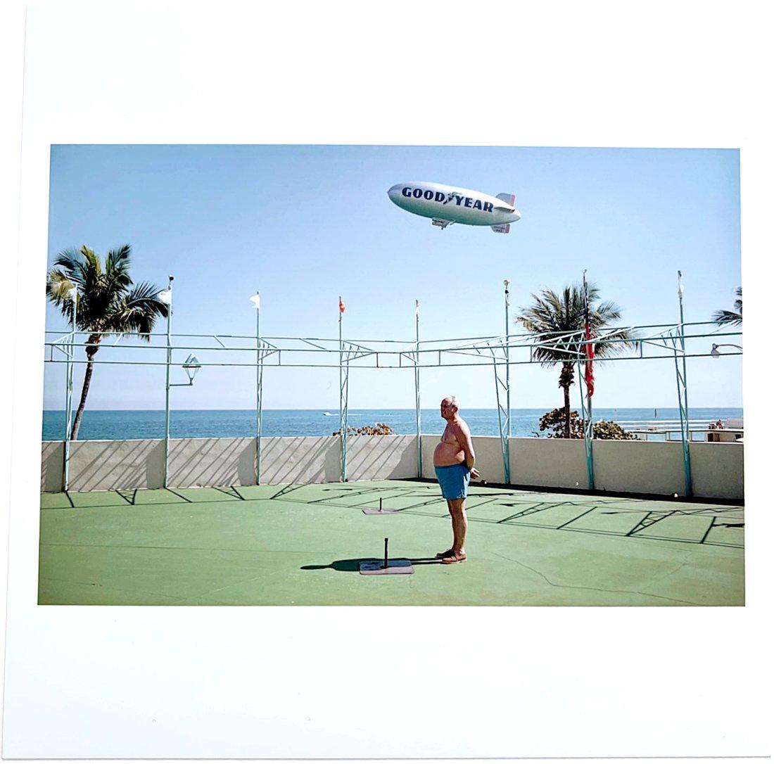 Joel Meyerowitz- Man and Blimp, Florida 1968: Color photograph signed in pen verso, 6" x 6" sheet Reserve: $230.00 Shipping: Domestic: Flat-rate of $15.00 to anywhere within the contiguous U.S. International: Foreign shipping rates are determined