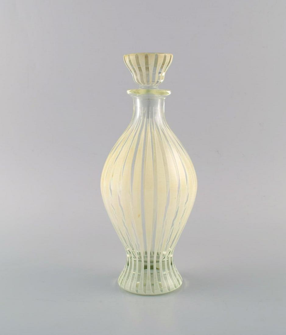 Bengt Orup for Johansfors. Strikt carafe in mouth-blown art glass. 1950s / 60s.: Bengt Orup for Johansfors. Strikt carafe in mouth-blown art glass. 1950s / 60s. Measures: 24 x 9.5 cm. In excellent condition. Reserve: $294.00 Shipping: Domestic: Shipping rates are determined by des