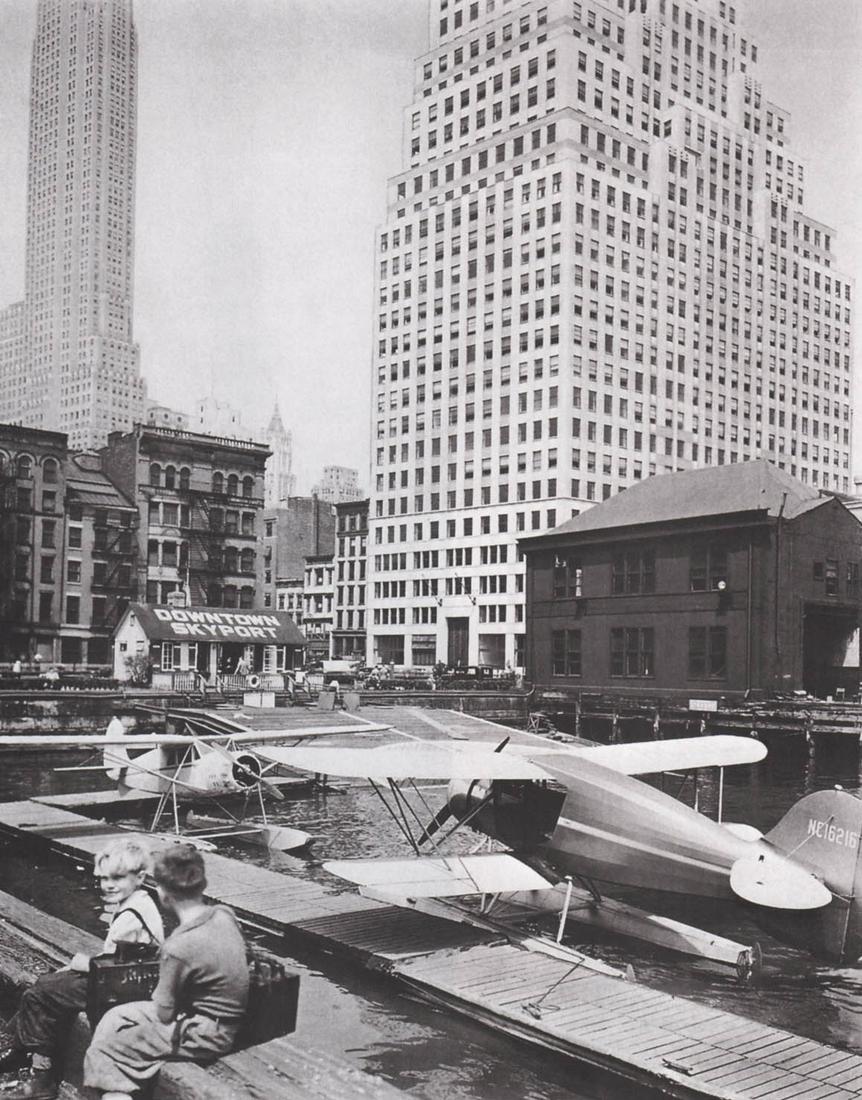 BERENICE ABBOTT- Downtown Skyport, NYC, 1936: Artist: BERENICE ABBOT Print Title: Watuppa, Brooklyn, 1936 Medium: Photo-lithograph Printed in: the US, 2010s Image Size: approx. 7 x 8.5” Berenice Abbott (1898 – 1991),was an American ph