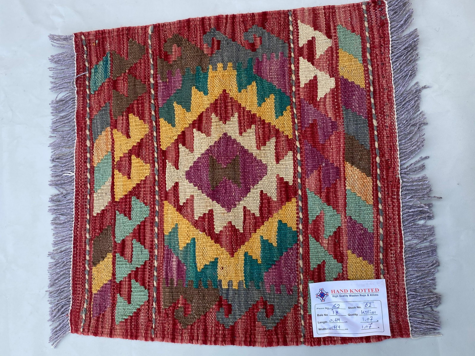2' x 2' Red Kilim Rug K-62: Title: 2' x 2' Red Kilim Rug K-62 Description: Size in Feet: Width: 2' x Length: 2' Size in Inches: Width: 24 in x Length: 24 in Colors: Red, Ivory, Yellow, Light Brown Weave: 100% Handmade Style: Geo