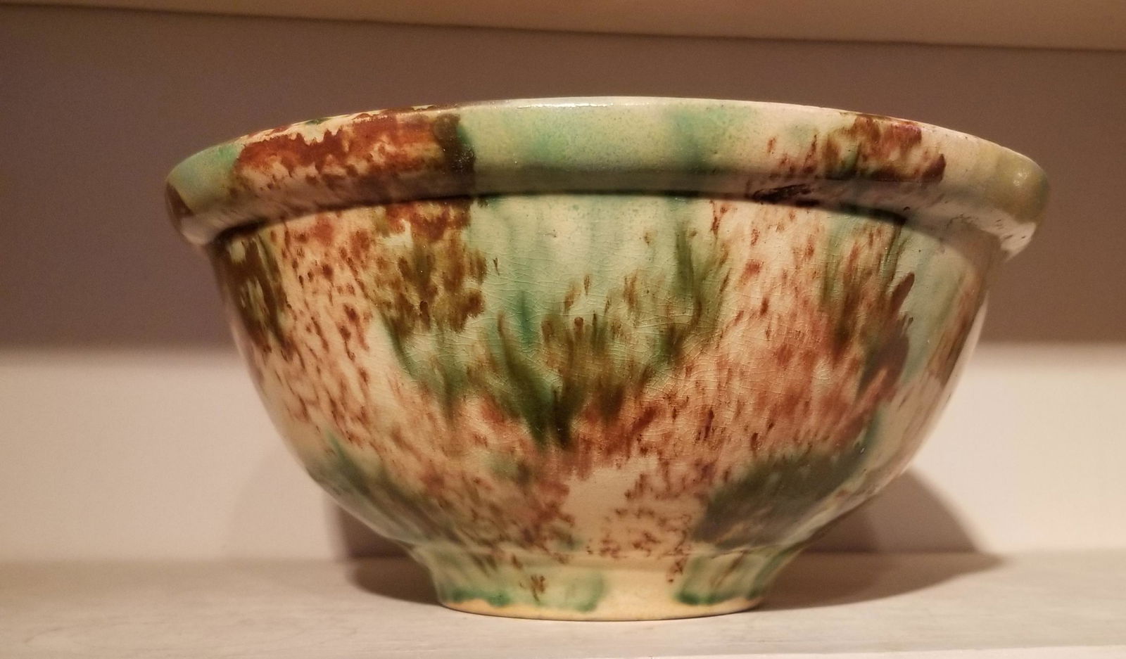 Yellowware bowl made by Brighton Pottery Co: 1905-1907. Multicolored glaze, 9". Shipping: Domestic: Flat-rate of $17.00 to anywhere within the contiguous U.S. International: Foreign shipping rates are determined by destination. International shi