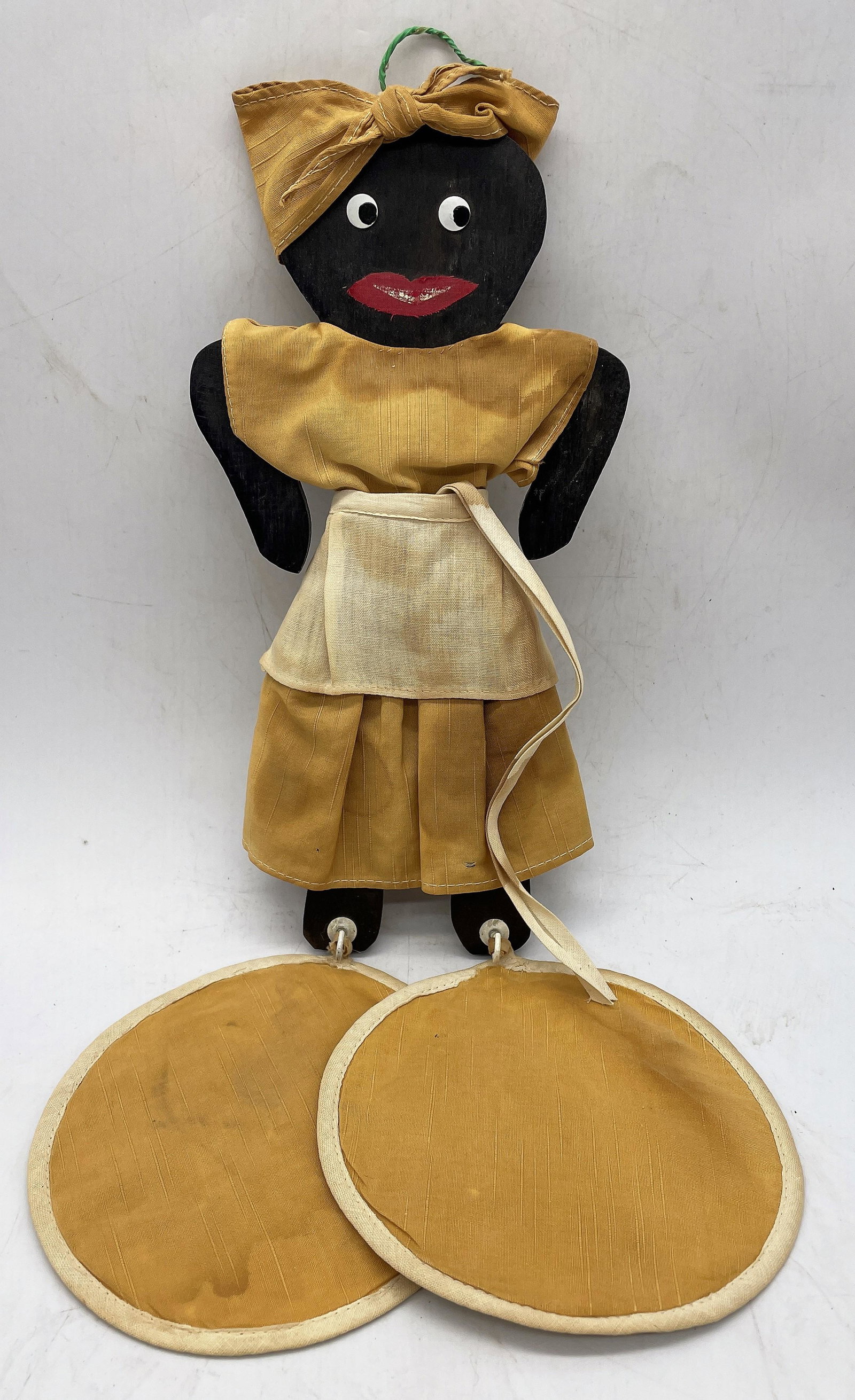 BLACK AMERICANA MAMMY POTHOLDER HANGER WITH POT HOLDERS: Title: BLACK AMERICANA MAMMY POTHOLDER HANGER WITH POT HOLDERS Date/Period: Dimension: APPROX 11" Material: mixed materials Additional Information: BLACK AMERICANA VINTAGE WOODEN POTHOLDER HANGER WITH