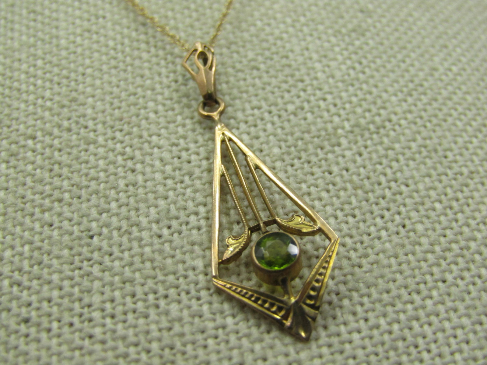 Edwardian 10kt Peridot Necklace, 18.5".: Edwardian 10kt Peridot Necklace, 18.5". The chain is more modern and signed with a G with an arrow through it. The pendant is 1-3/8" long with a swing bail with tapered open work design. The pendant i