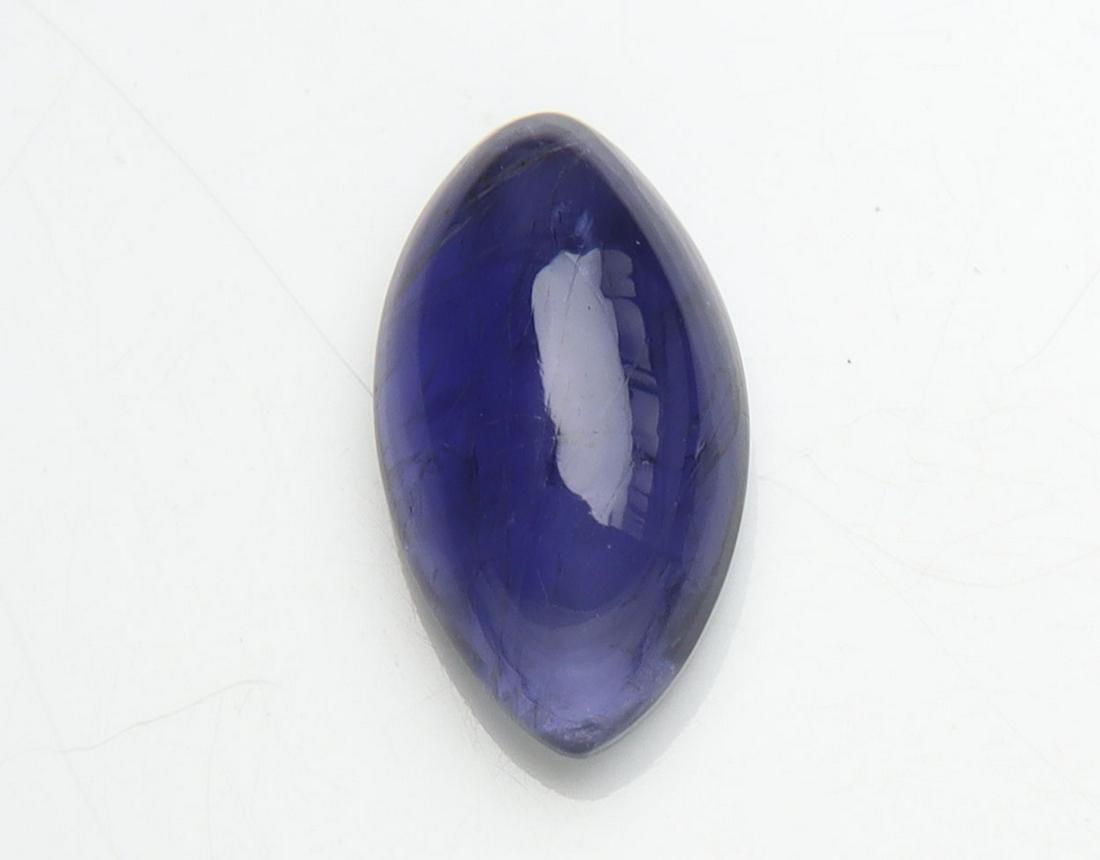1.43 cts Natural Iolite: No Reserve! Title: 1.43 cts Natural Iolite Additional Information: Gemstone : Natural Iolite Shape and cut : Marquies Cabochan Weight : 1.43 carats Measurements : 10.43x5.70x3.55 mm , Color : Violite