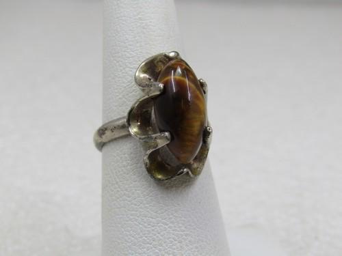 Vintage Sterling Tiger's Eye Ring, Sz. 6.25, Mexico: Vintage Sterling Tiger's Eye Ring, Sz. 6.25, Mexico. Marked .925 and tested. Age is appx. 1970's-1980's. Appx. 4.73 gr. Marquise tiger's eye cabochon that is appx. 15mm by 7.5mm in an open dramatic sc
