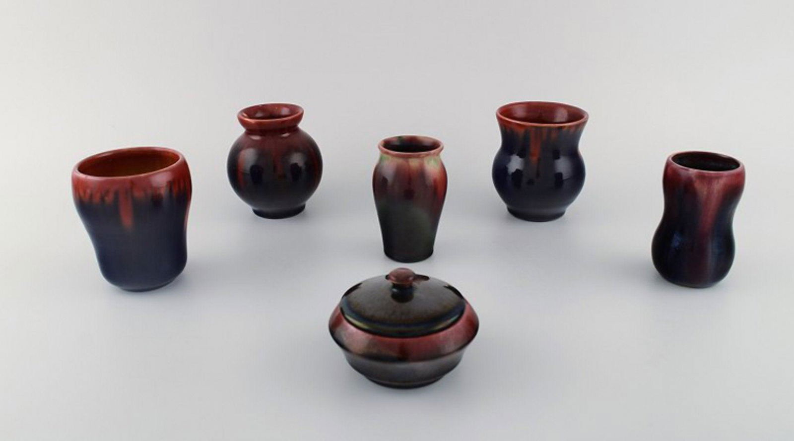 Michael Andersen, Bornholm. Five vases and a lidded jar in glazed ceramics. Beautiful glaze in red: Michael Andersen, Bornholm. Five vases and a lidded jar in glazed ceramics. Beautiful glaze in red and dark shades. 1950's. Largest vase measures: 9 x 8.5 cm. The lidded jar measures: 9.5 x 6 cm. In v