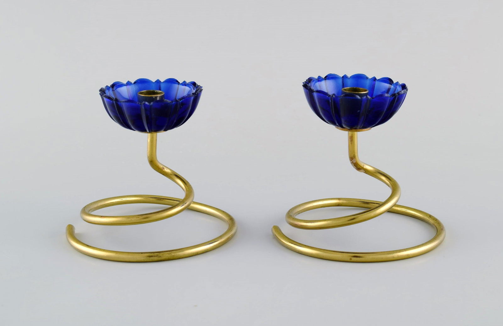Gunnar Ander for Ystad Metall. Two candlesticks in brass and blue art glass shaped like flowers.: Title: Gunnar Ander for Ystad Metall. Two candlesticks in brass and blue art glass shaped like flowers. 1950s. Description: Gunnar Ander for Ystad Metall. Two candlesticks in brass and blue art glass