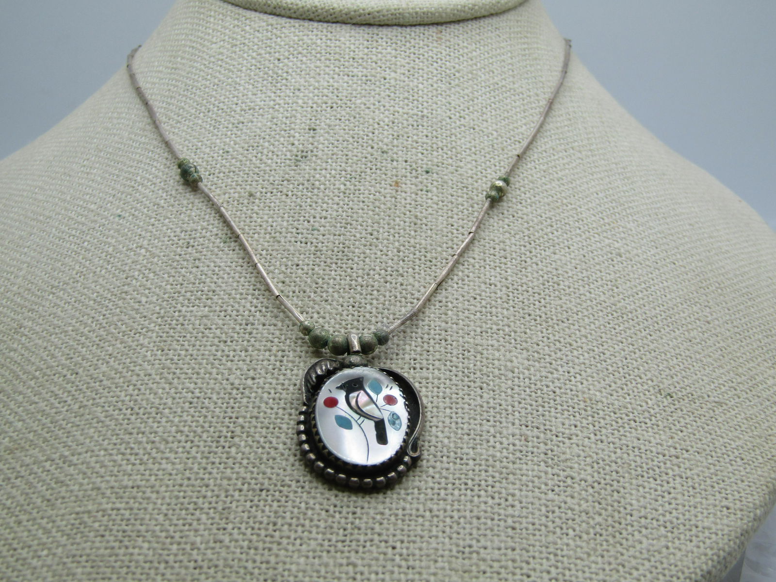 Vintage Sterling Southwestern Inlaid Cardinal Necklace, 16": Vintage Sterling Southwestern Inlaid Cardinal Necklace, 16" This has a shadow box background with beaded and curved framing and a feather accent with a raised bezel-set inlaid black headed and framed
