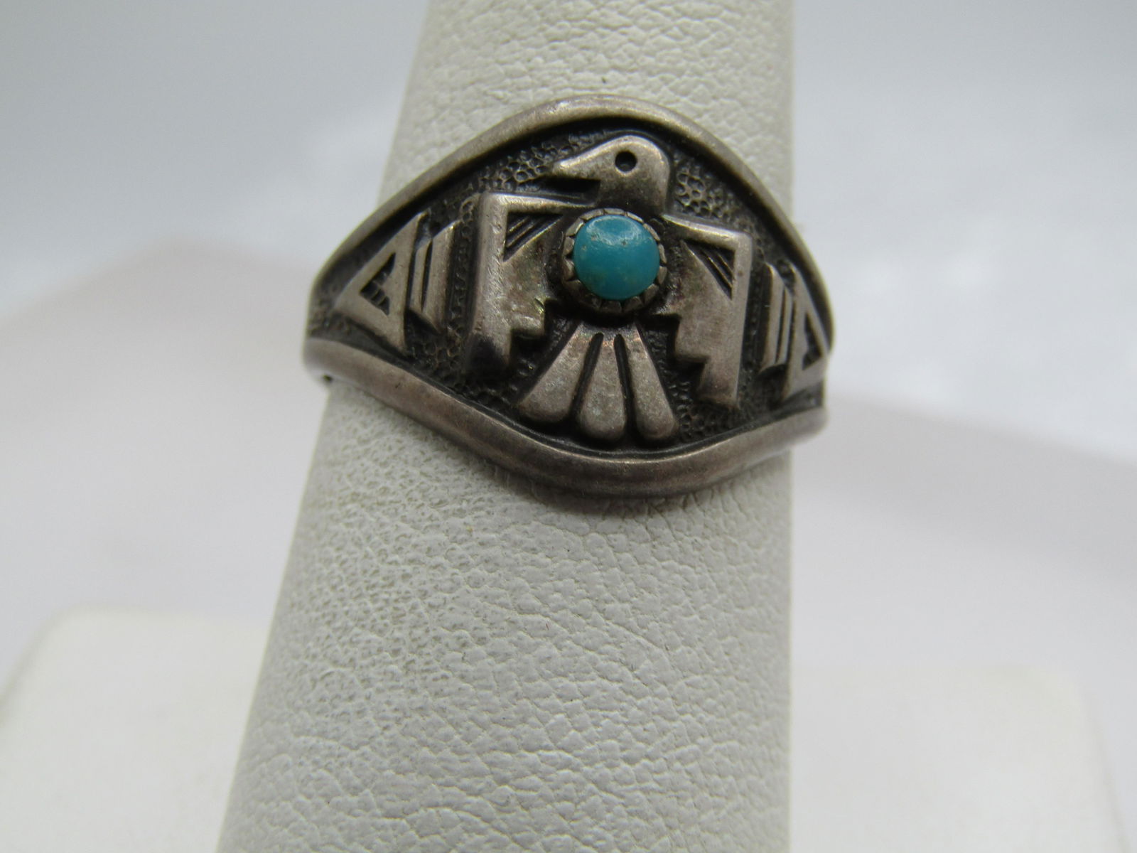 Vintage Sterling Turquoise Thunderbird Ring, Sz. 8. Bell Trading, Unisex.: Vintage Sterling Southwestern Turquoise Thunderbird Ring, Sz. 8. Bell Trading. This has repousse thunderbird with a 3mm sawtooth bezel-set turquoise stone and other raised designs. The ring is appx. 1