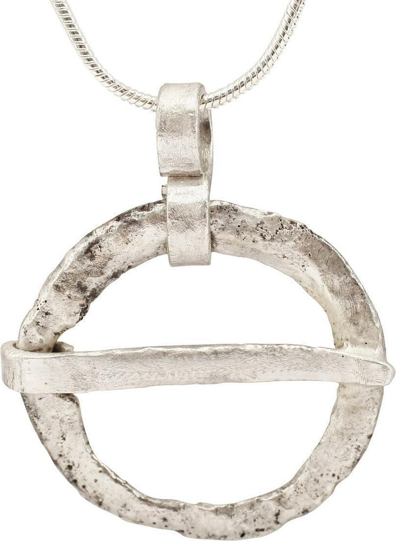 VIKING PROTECTIVE BROOCH NECKLACE, 10th-11th CENTURY AD: Bronze, well just under 1" diameter. Low rounded faces on both sides forming rounded edges. Textured from burial. Worn in numbers, these were decorative as well as serving as a measure of protection f