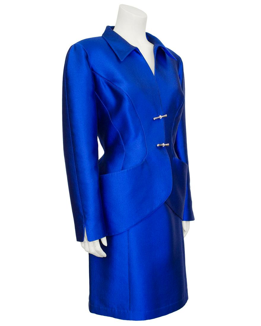 1990s Thierry Mugler Blue Metallic Skirt Suit: Thierry Mugler was known for his avant-garde and architectural, yet hyper-feminine designs, and this 1990s skirt suit is no exception. Crafted from a metallic royal blue wool silk blend, this suit is