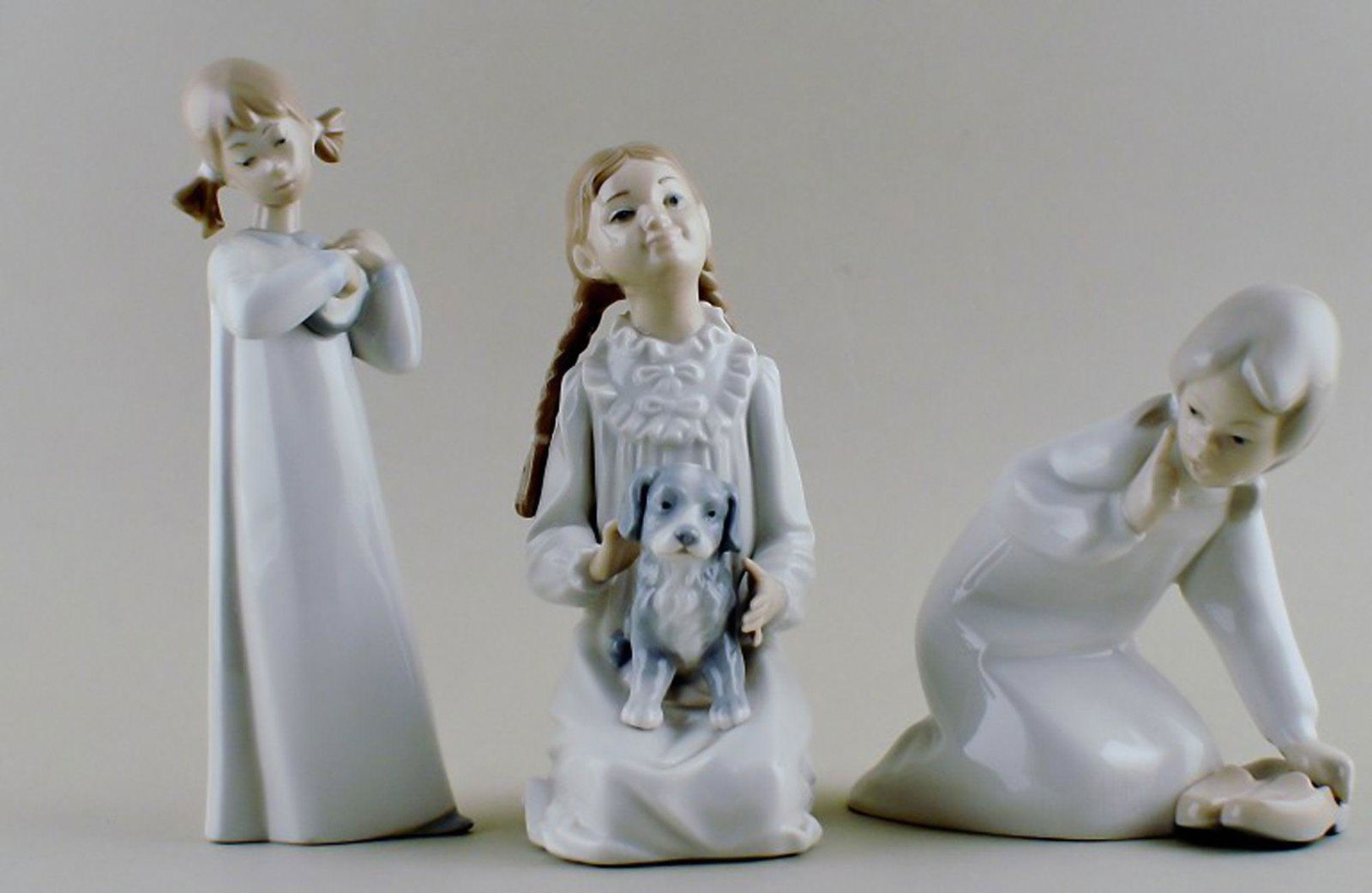 Two Lladro figurines and one Nao in porcelain. (1 of 6)