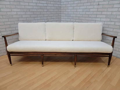 Mid Century Modern Danish Walnut Frame Sofa by Ib Kofod-Larsen Newly Upholstered: Vintage from the 1960s Materials: shearling, wood, walnut, wool, sheep wool Overall width: 69 inches Overall height: 30 inches Overall depth: 30 inches Seat height: 18 inches Description Mid Century M