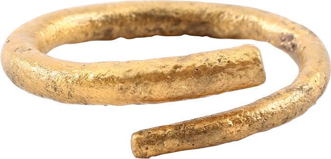 VIKING COIL RING C.900-1050 AD SIZE 11: Size 11. Gilt bronze. Rounded section band in full coil with about 1/8 turn overlap. Slightly tapered through its length. 3.3mm thickest. The coil or helix was a favorite form for Vikings and evidentl