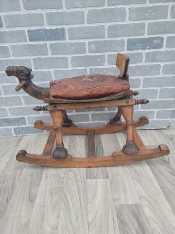 Vintage Turkish Design Carved Wood Rocking Camel: Vintage from the 1970s Materials: leather, wood Description Vintage Turkish Design Carved Wood Rocking Camel One of a kind and unique carved wood rocking camel. It’s a child’s size, hand m