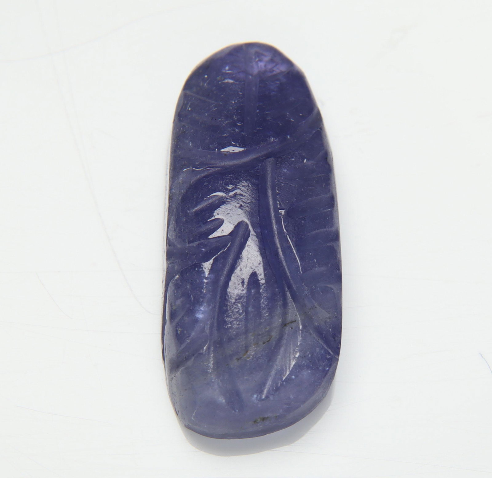 12.82 Cts Natural Tanzanite Carving: No Reserve! Title: 12.82 Cts Natural Tanzanite Carving Additional Information: Gemstone : Natural Tanzanite Carving Origin: Tanzania Weight : 12.82 carats Dimensions : 22.34x9.47x5.80 mm Shape/Cut: Fa