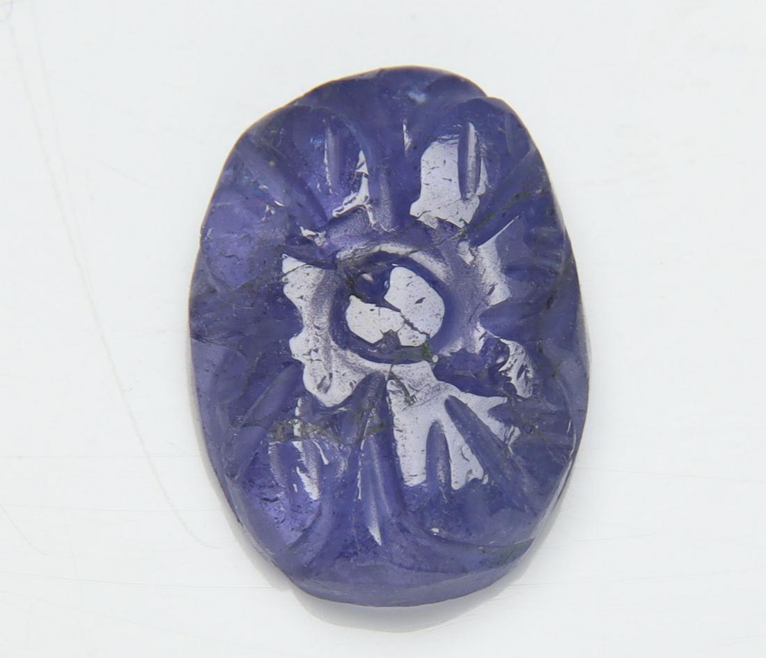 6.45 Cts Natural Tanzanite Carving: No Reserve! Title: 6.45 Cts Natural Tanzanite Carving Additional Information: Gemstone : Natural Tanzanite Carving Origin: Tanzania Weight : 6.45 carats Dimensions : 14.33x10.64x4.10 mm Shape/Cut: Ova