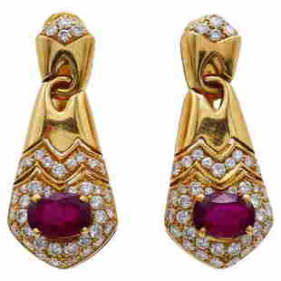 Vintage Bulgari Ruby Diamond 18k Yellow Gold Earrings: Title: Vintage Bulgari Ruby Diamond 18k Yellow Gold Earrings Description: Classy earrings created by Bulgari in the 1980s. Made of 18k yellow gold, the earrings feature oval faceted ruby accented with
