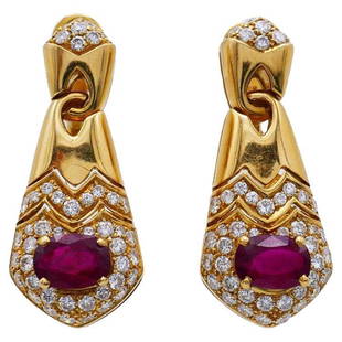 Vintage Bulgari Ruby Diamond 18k Yellow Gold Earrings: Title: Vintage Bulgari Ruby Diamond 18k Yellow Gold Earrings Description: Classy earrings created by Bulgari in the 1980s. Made of 18k yellow gold, the earrings feature oval faceted ruby accented with