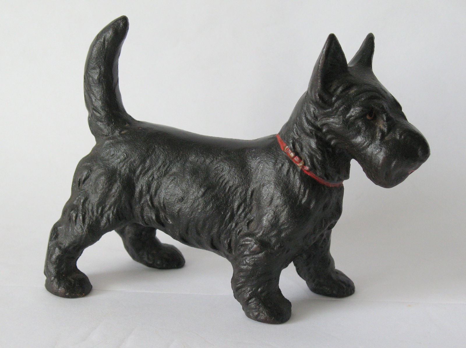 Antique cast iron Scottie door stop.: Title: Antique cast iron Scottie door stop. Date/Period: 1930's Dimension: Additional Information: Nice antique cast iron Scottie dog door stop in great original paint & condition made by Hubley Shipp