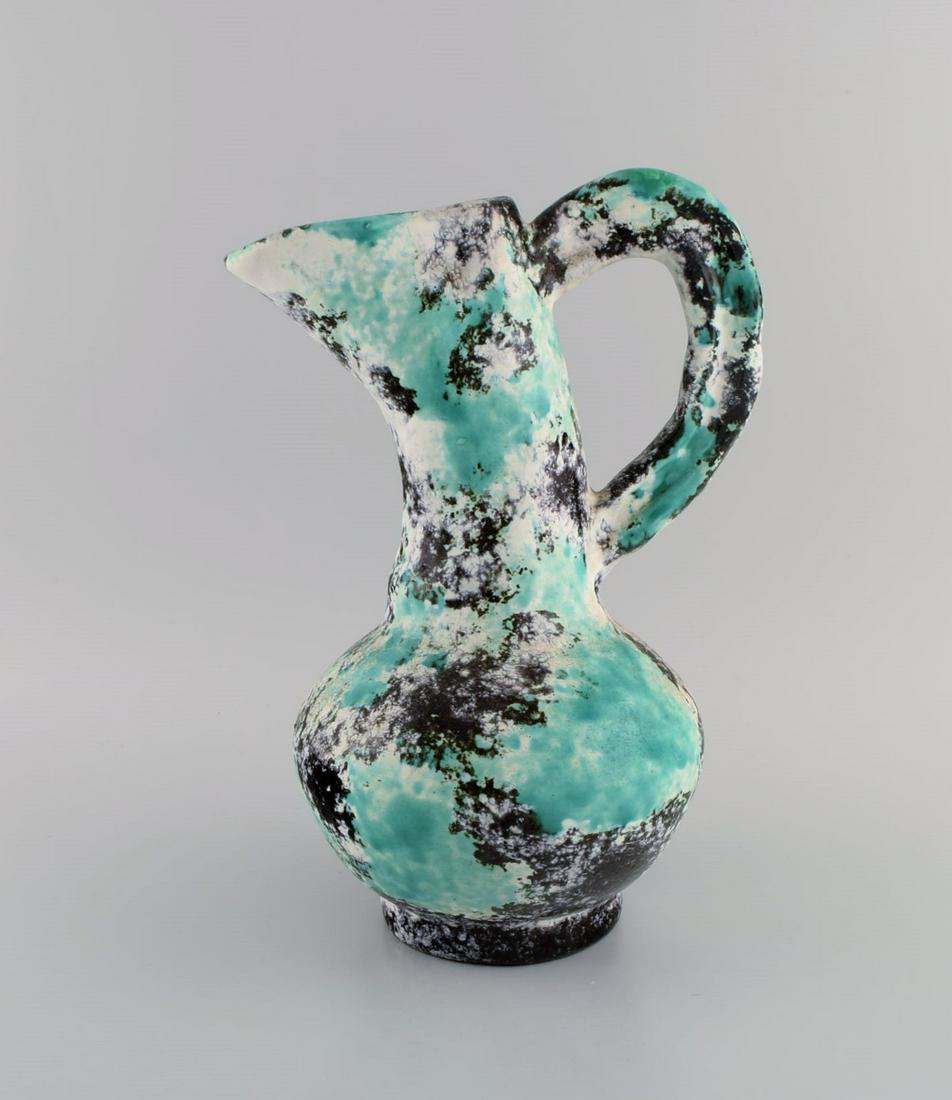 Jerome Massier (1850-1916) for Vallauris. Antique freeform pitcher in glazed stoneware. Beautiful: Jerome Massier (1850-1916) for Vallauris. Antique freeform pitcher in glazed stoneware. Beautiful polychrome glaze. Early 20th century. Measures: 31 x 20 cm. In excellent condition. Stamped. Reserve: