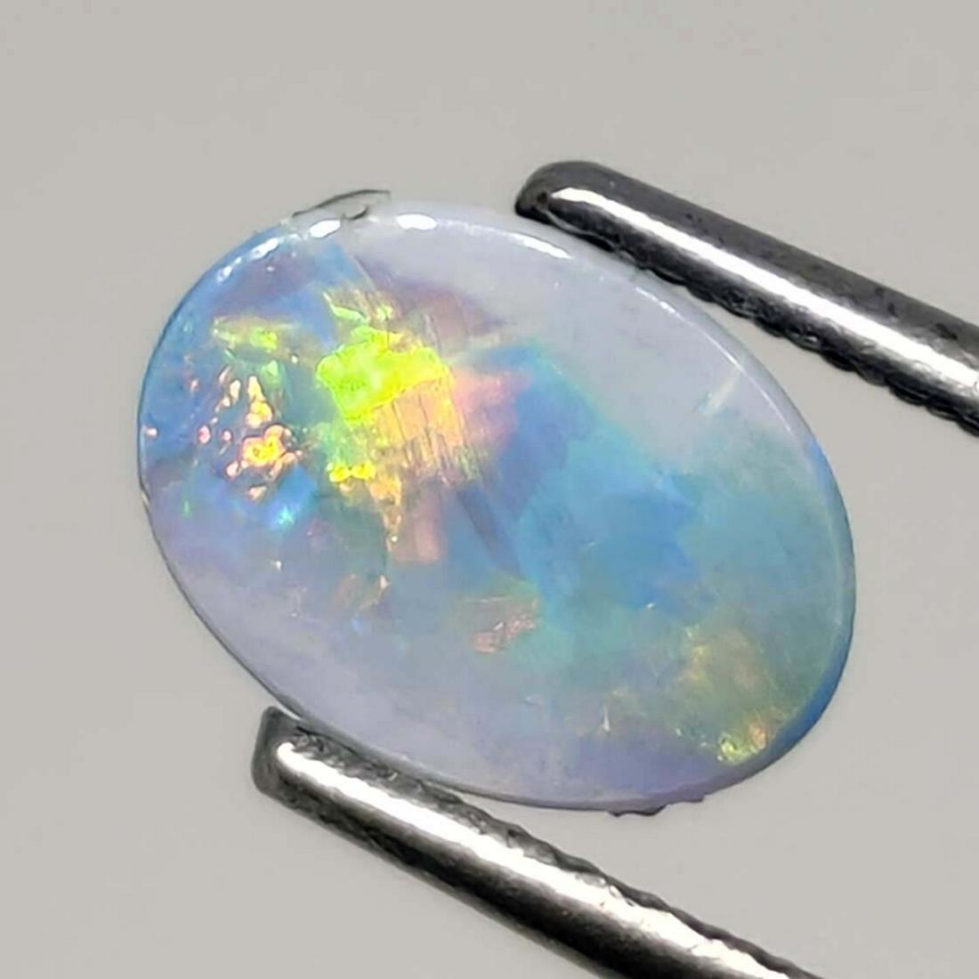 0.90 ct Australian Doublet Opal: No Reserve! Title: 0.90 ct Australian Doublet Opal Additional Information: Gemstones: Australian Doublet Opal Carat Weights: 0.90 ct Size/Dimensions: 9 X 6 mm Materials & Techniques: Opal Shipping: Do