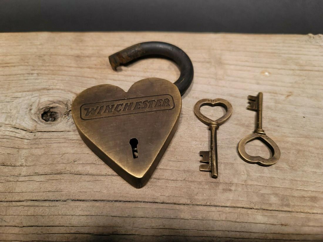 Brass Heart Winchester Firearms Ammo Box Padlock Lock: 3" tall x 4 1/4" Wide Nice reproduction brass winchester padlock! This lock is fully functional! Hard to tell its age. Heavy iron and brass. Great aged patina throughout. Limited quantity available! R